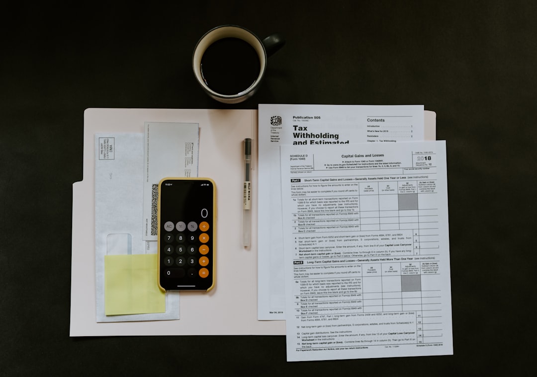 services-03 black-android-smartphone-near-ballpoint-pen-tax-withholding-certificate-on-top-of-white-folder-m98nrbuzbpc